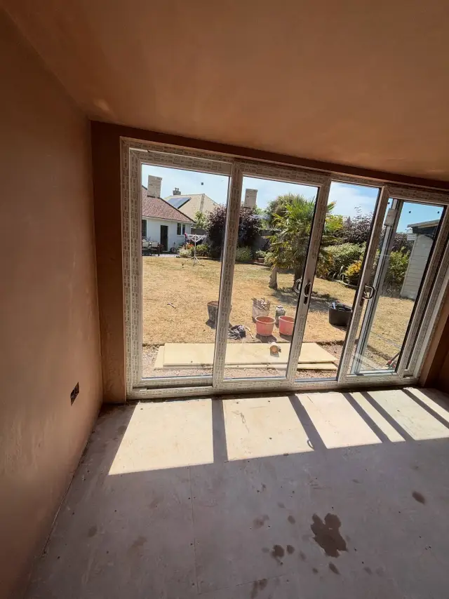 Large room with pristine beige plaster finish