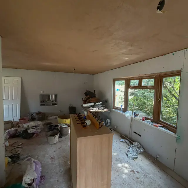 Large room with tan plaster and natural light